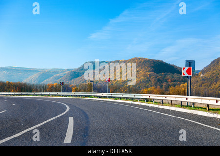 Mountain road bright autumn day with blue sky Stock Photo