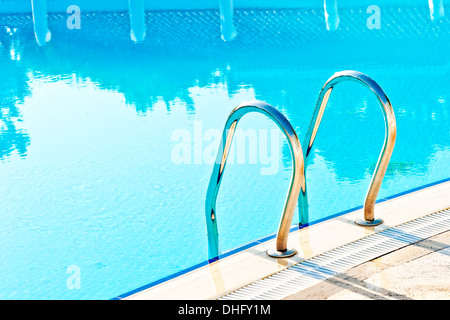 steps leading to the pool and reflection in water Stock Photo