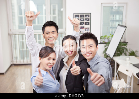 Group of young business people giving the Thumbs-up Sign Stock Photo