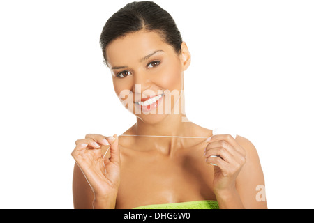 Attractive woman with dental floss. Isolated on white.  Stock Photo