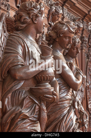 ANTWERP, BELGIUM - SEPTEMBER 5: Carved statue of angel with the mug in St. Charles Borromeo church on September 5, 2013 Stock Photo