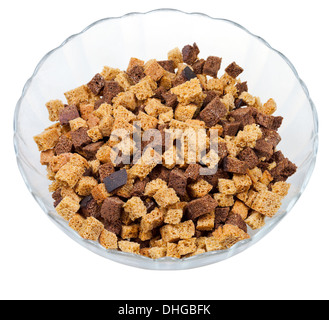 dried rye bread crust pieces in glass bowl isolated on white background Stock Photo