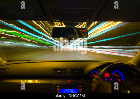 view through the windscreen of a moving car with motion blur and different sections on the motorway with road works cars lorries Stock Photo