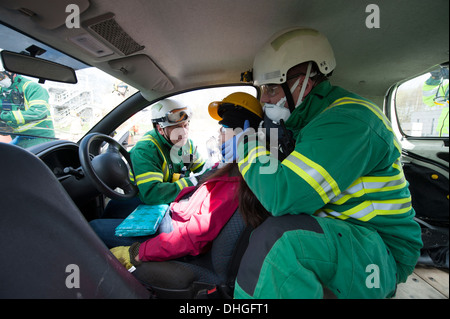 Paramedics stabilising C Spine of car crash casualty SIMULATION Stock Photo