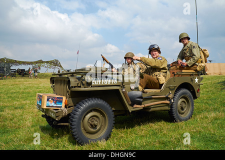 Men posing in WW2 US Army uniforms in a 1943 Willys MB Jeep. Rauceby War Weekend, Lincolnshire, England. Stock Photo