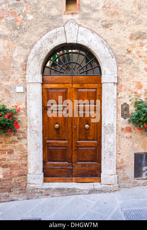 Old elegant wooden door in Italian village Stock Photo