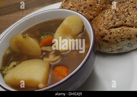 homemade vegetarian stew served with seeded bread roll Stock Photo