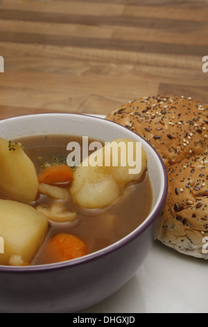 homemade vegetarian stew served with seeded bread roll Stock Photo