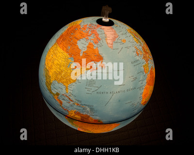 Planet Earth as depicted on a lighted globe. Stock Photo