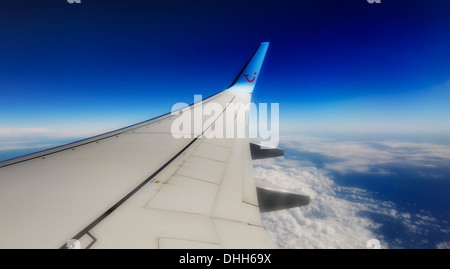 wing of TUI boeing 757-200 aeroplane in flight at 36000 feet Stock Photo