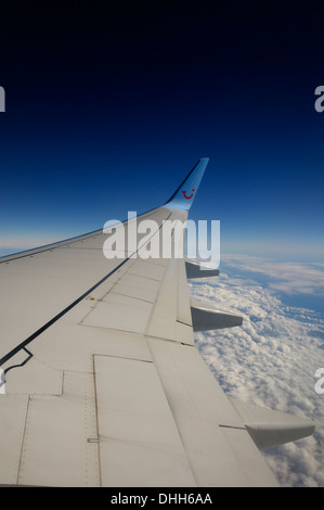 wing of TUI boeing 757-200 aeroplane in flight at 36000 feet Stock Photo