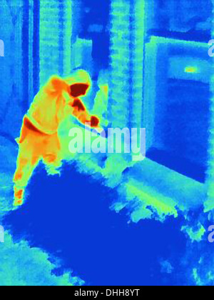 Thermal photograph of a burglar breaking into a house