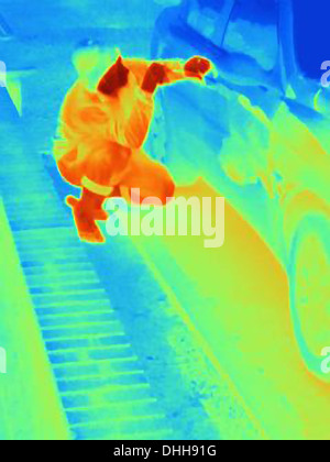 Thermal photograph of a burglar breaking into a car Stock Photo