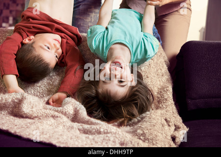Brother and sister upside down, laughing Stock Photo