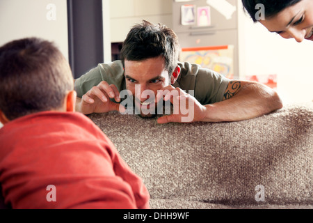 Father and son playing on sofa Stock Photo