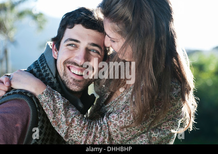 Young woman hugging boyfriend Stock Photo