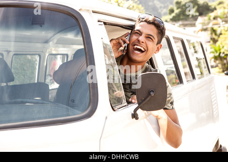 Man in van talking on mobile phone Stock Photo