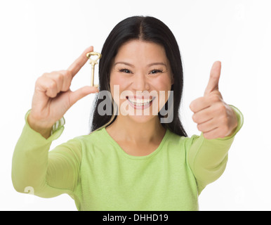 Asian woman hold old key on white Stock Photo