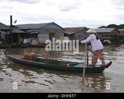 Mekong river Cambodia floating village.  People living on the water surviving by fishing woman rowing boat Stock Photo