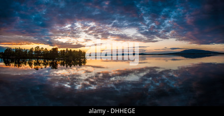 Reflection on lake at dawn, Arjeplog, Lapland, Sweden Stock Photo