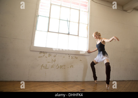 Ballet dancer on tip toes in studio Stock Photo
