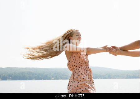 Young couple holding hands, woman with long blonde hair Stock Photo