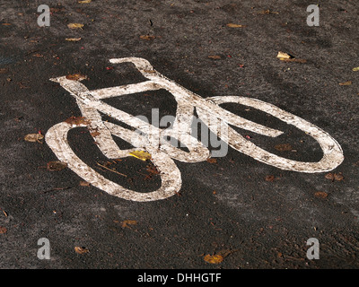 Cycle lane symbol road marking -  a painted bicycle symbol indicating a designated cycle route. Stock Photo