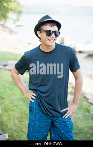 Portrait of young man wearing hat and sunglasses Stock Photo