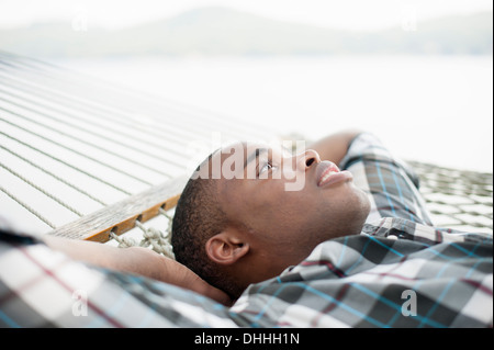 Young man lying on hammock