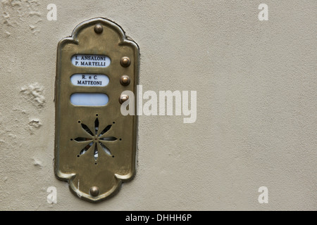 old Fashioned brass door bell intercom on a wall Stock Photo