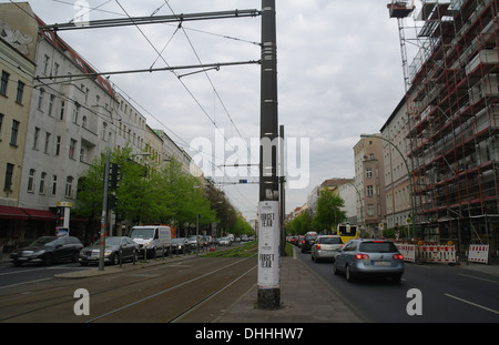 Grey sky morning rush-hour view cars moving and queuing either side of electric tramway, Torstrasse at Schonhauser Allee, Berlin Stock Photo