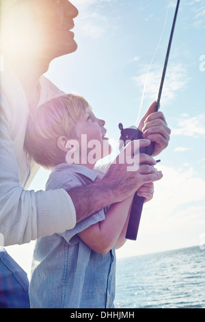 Grandfather and grandson holding fishing rod, Utvalnas, Sweden Stock Photo