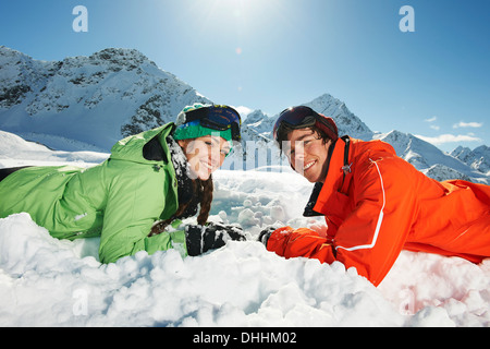 Couple lying in snow, Kuhtai, Austria Stock Photo