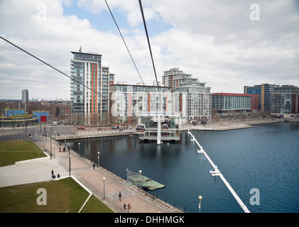 View of Emirates Air Line cable car and Royal Docks terminal crossing River Thames in East London. Stock Photo