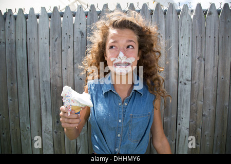 Teenage girl with ice cream on face Stock Photo