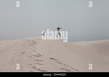 Boy and girl playing, White Sands National Park, New Mexico, USA Stock Photo
