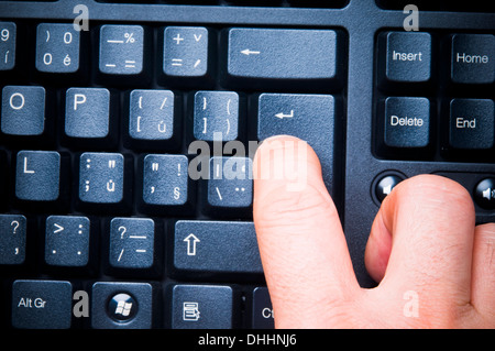 pressing a keyboard enter key Stock Photo