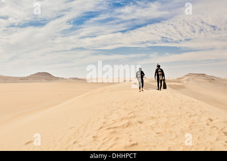 Two men in wetsuits, Great Sand Sea, Sahara Desert, Egypt, Africa Stock Photo