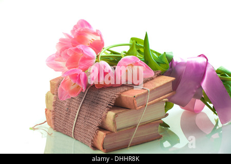 Pink tulips on old books Stock Photo