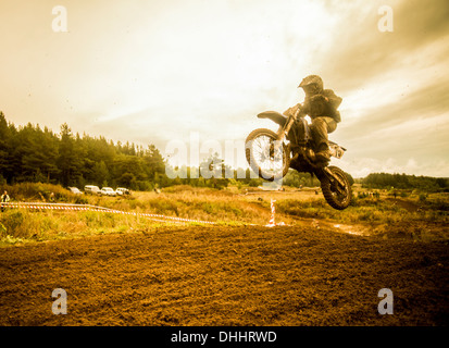 Boy mid air on motorcycle at motocross Stock Photo