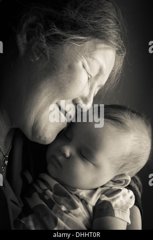 Portrait of grandmother holding baby granddaughter Stock Photo