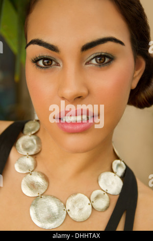 Portrait of young woman wearing circle necklace Stock Photo