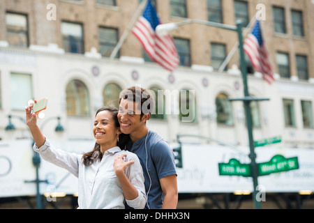 Couple taking photograph with mobile phone Stock Photo