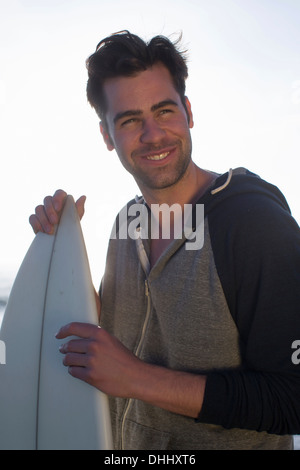 Young man holding surfboard, San Diego, California, USA Stock Photo