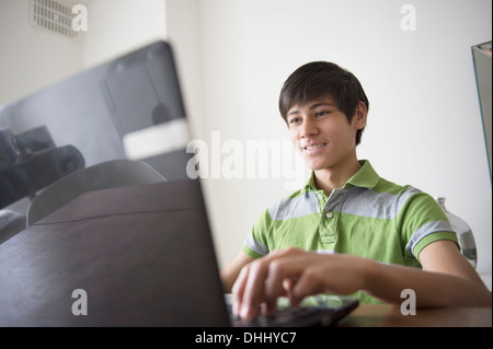 Teenage boy using laptop Stock Photo