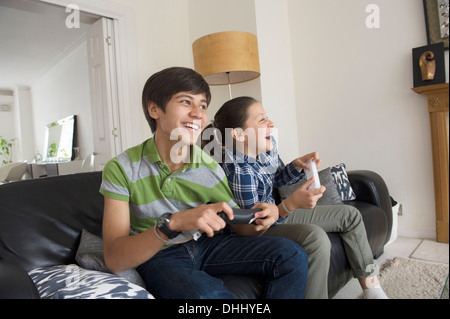 Brother and sister playing video game Stock Photo