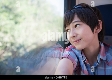 Boy looking out of train window Stock Photo