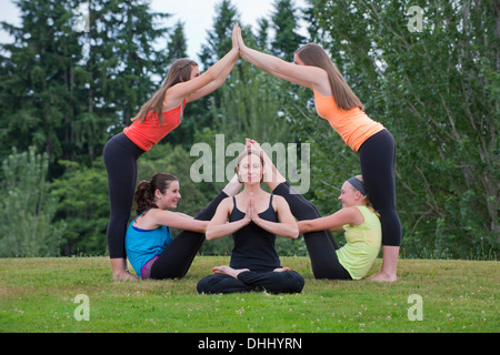 Teenage girls and tutor doing yoga Stock Photo