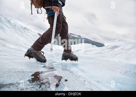 Young man walking on Mendenhall Glacier, Alaska, USA Stock Photo