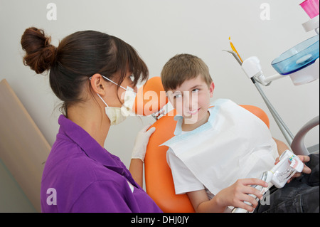 Patient practicing dental brushing on dentures Stock Photo